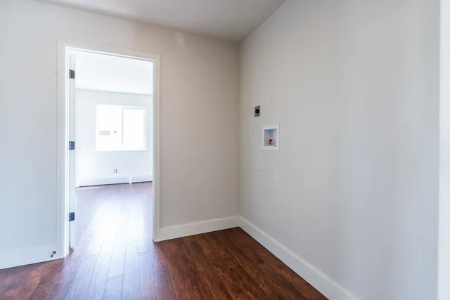 a view of a small space with wooden floor and a bathroom