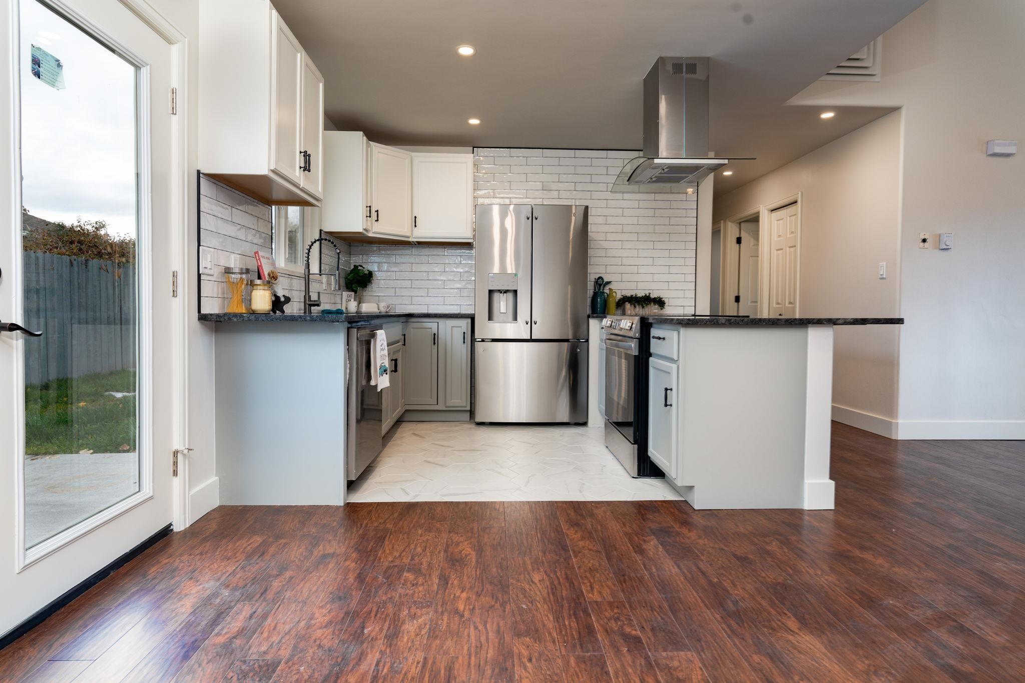 411 Cedar Glen Way Fruita, CO 81521 - Photo 6 of 25 a kitchen with stainless steel appliances granite countertop a refrigerator and a stove top oven