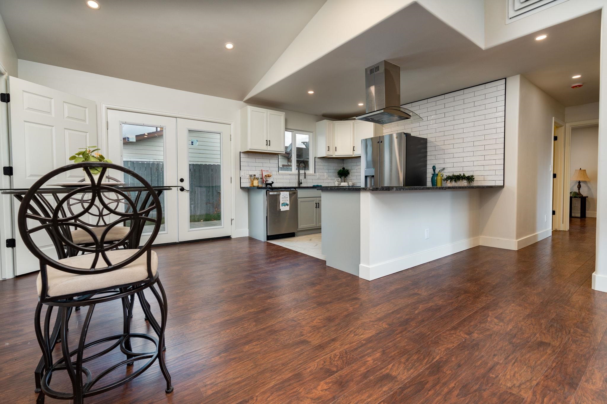 411 Cedar Glen Way Fruita, CO 81521 - Photo 8 of 25 a view of a kitchen with furniture and wooden floor