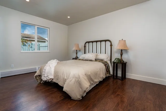 a bed sitting in a bedroom next to a window