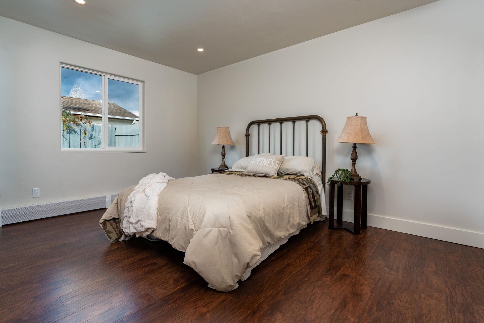 411 Cedar Glen Way Fruita, CO 81521 - Photo 9 of 25 a bed sitting in a bedroom next to a window