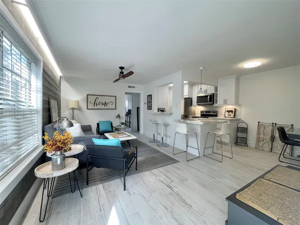 a living room with furniture and kitchen view