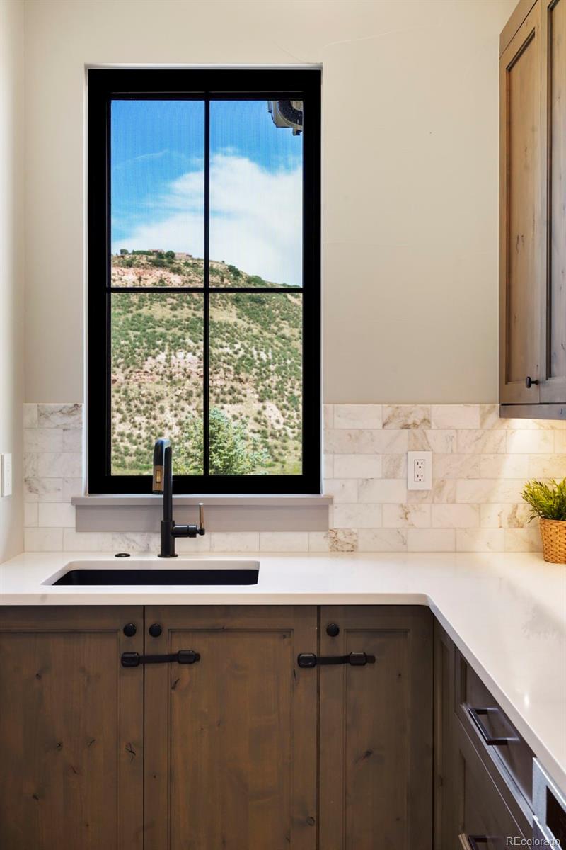 15411 Dinosaur Ridge Road Morrison, CO 80465 - Photo 11 of 50 a sink with a window