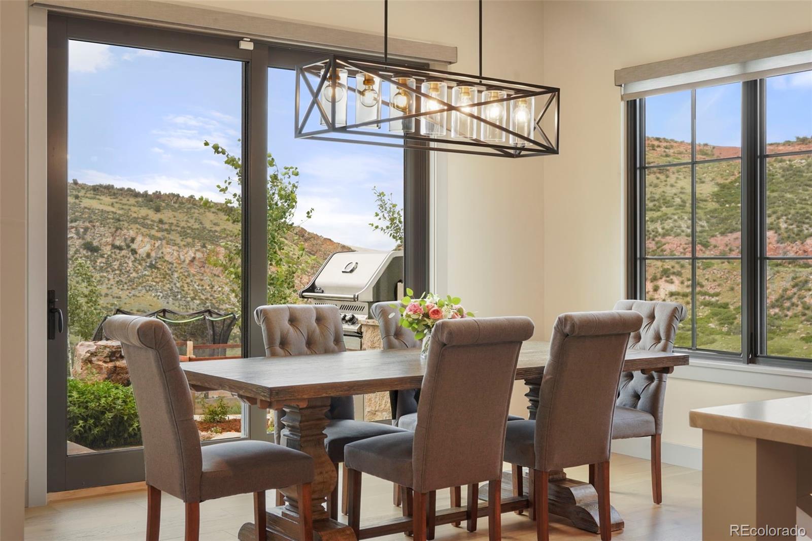 15411 Dinosaur Ridge Road Morrison, CO 80465 - Photo 12 of 50 a view of a dining room with furniture window and outside view