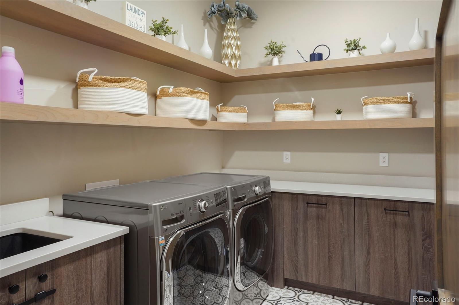 15411 Dinosaur Ridge Road Morrison, CO 80465 - Photo 17 of 50 a utility room with dryer and washer