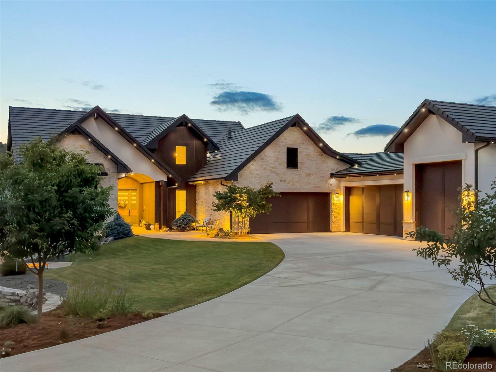 15411 Dinosaur Ridge Road Morrison, CO 80465 - Photo 2 of 50 a front view of a house with a yard and potted plants