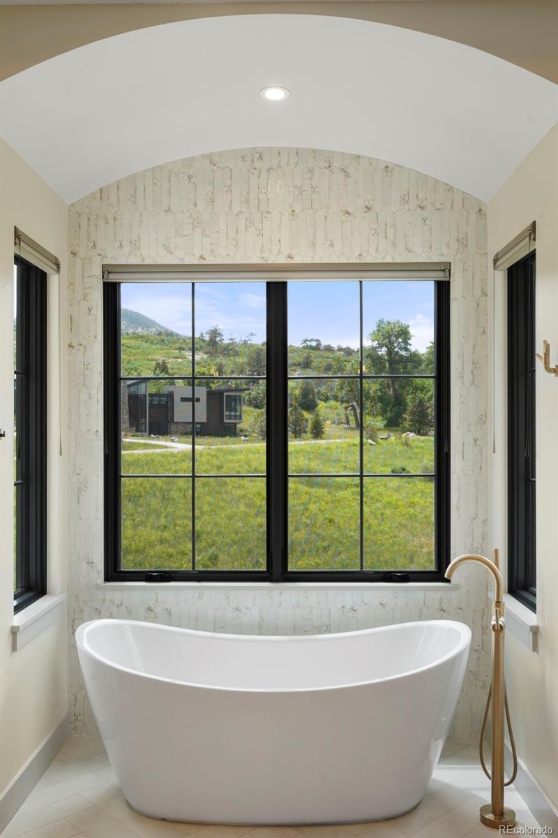 15411 Dinosaur Ridge Road Morrison, CO 80465 - Photo 21 of 50 a view of a bathtub in a room