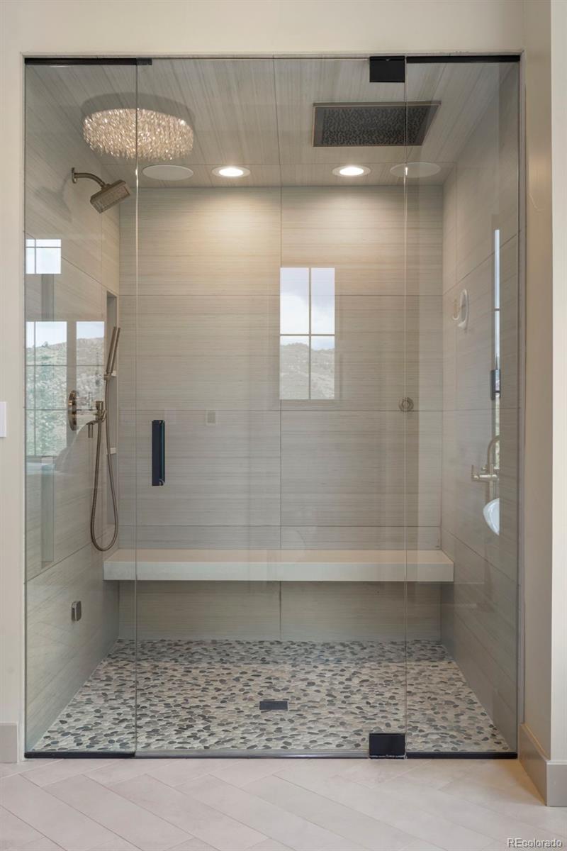 15411 Dinosaur Ridge Road Morrison, CO 80465 - Photo 23 of 50 a bathroom with a shower