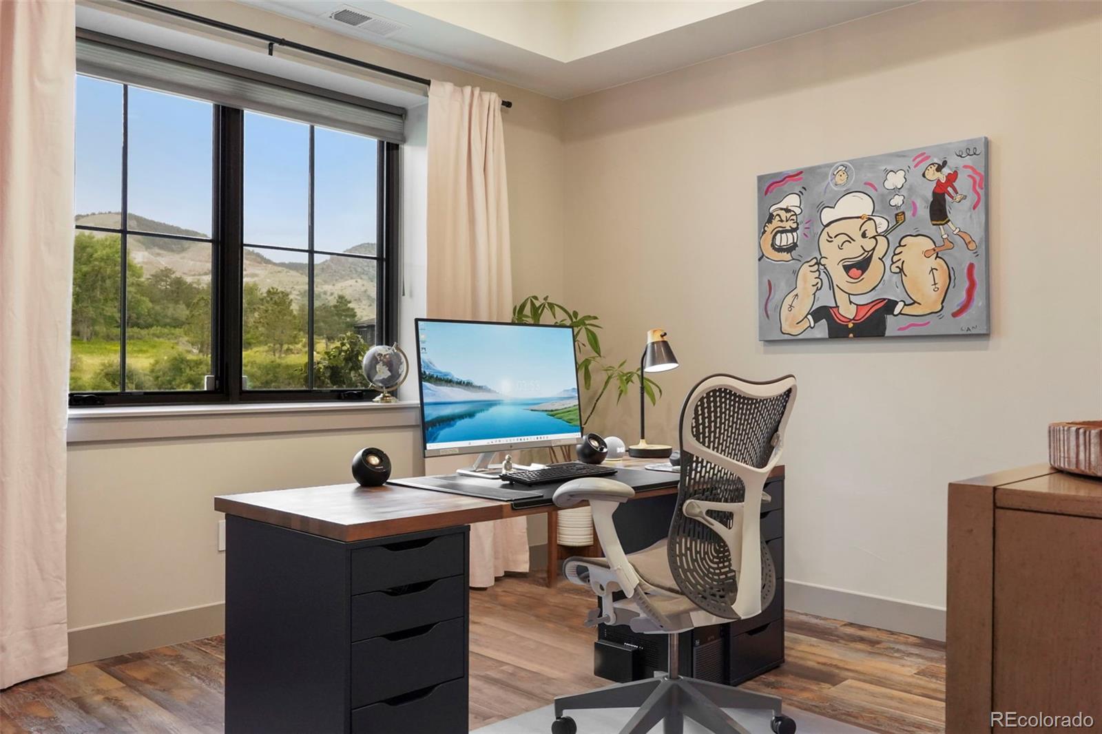 15411 Dinosaur Ridge Road Morrison, CO 80465 - Photo 36 of 50 a view of a workspace with furniture and a window