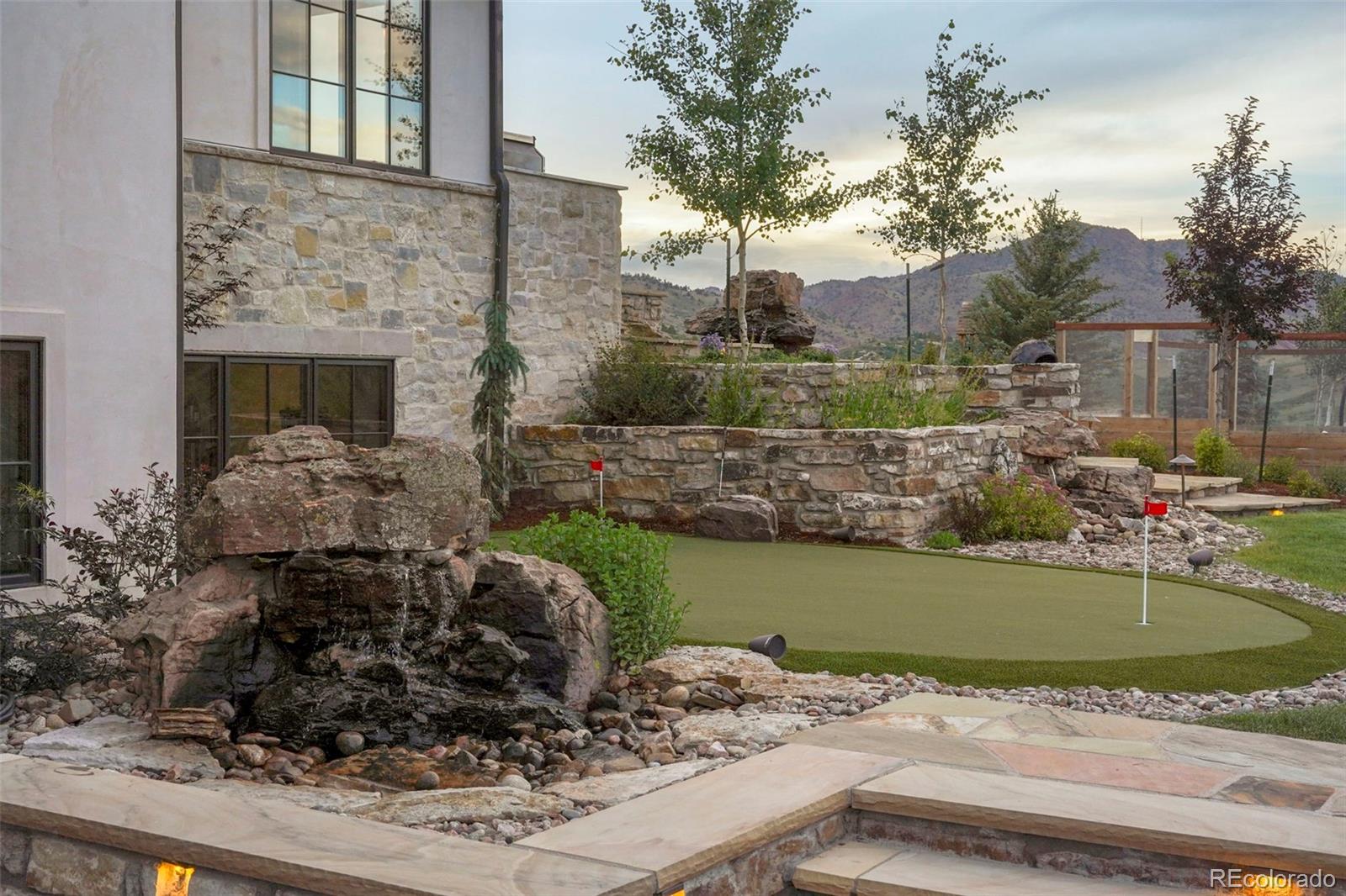 15411 Dinosaur Ridge Road Morrison, CO 80465 - Photo 38 of 50 a view of a couches and a fire pit in the backyard