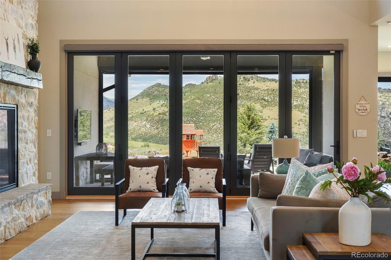 15411 Dinosaur Ridge Road Morrison, CO 80465 - Photo 4 of 50 a living room with furniture and a large window