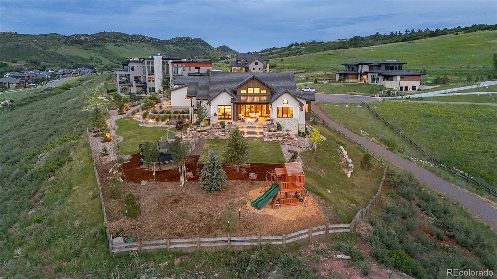 15411 Dinosaur Ridge Road Morrison, CO 80465 - Photo 43 of 50 an aerial view of a house with a garden and lake view
