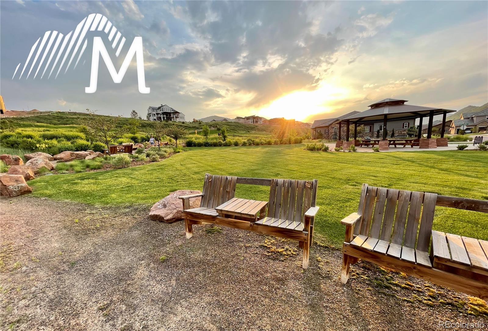 15411 Dinosaur Ridge Road Morrison, CO 80465 - Photo 48 of 50 a view of a lake with table and chairs with wooden floor and fence