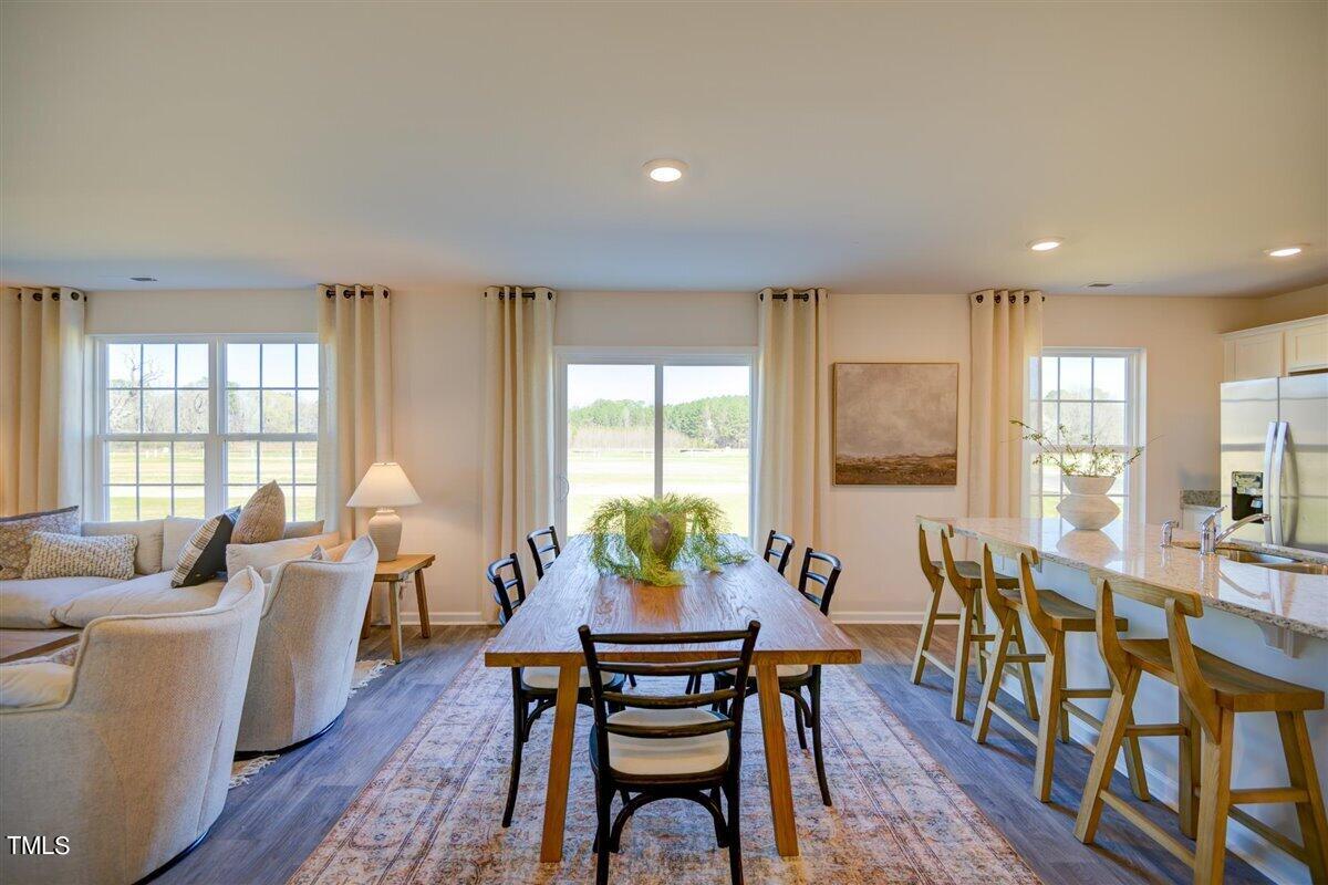 6016 Howth Way Raleigh, NC 27610 - Photo 13 of 35 a dining room with furniture window and wooden floor