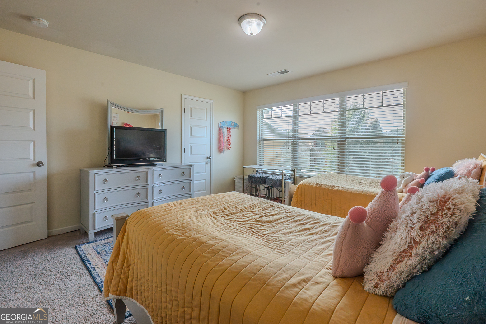 1180 Lehavre Court Hampton, GA 30228 - Photo 27 of 43 a bedroom with a bed and a flat screen tv