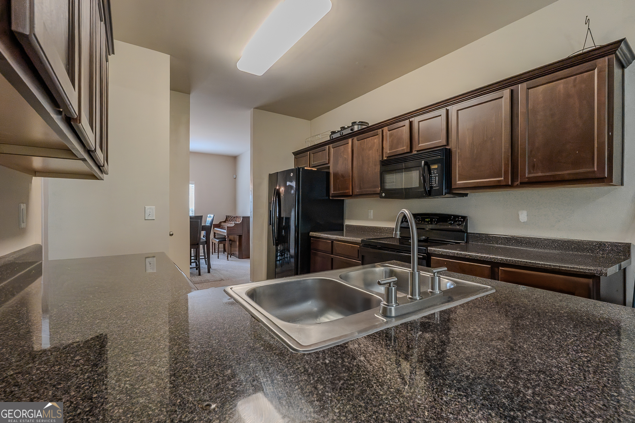 1180 Lehavre Court Hampton, GA 30228 - Photo 7 of 43 a kitchen with stainless steel appliances granite countertop a sink a stove and a refrigerator