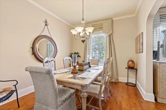 a view of a dining room with furniture and chandelier