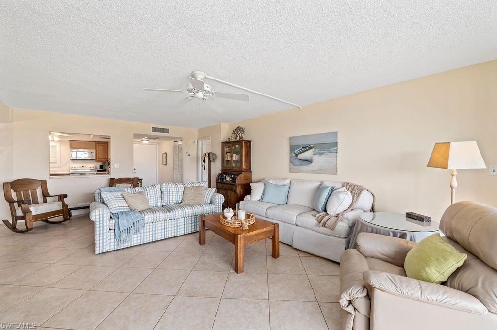 415 Augusta Boulevard, Unit 309 Naples, FL 34113 - Photo 11 of 36 a living room with furniture and a couch