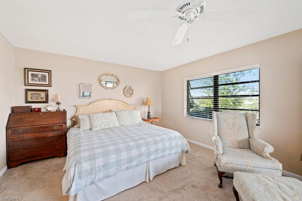 415 Augusta Boulevard, Unit 309 Naples, FL 34113 - Photo 16 of 36 a bedroom with a bed and a window