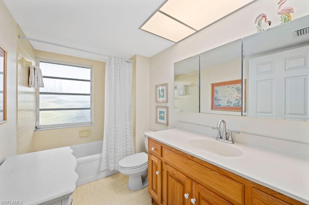 415 Augusta Boulevard, Unit 309 Naples, FL 34113 - Photo 19 of 36 a bathroom with a sink a toilet and shower