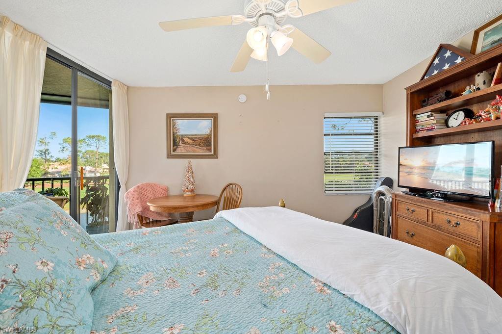 415 Augusta Boulevard, Unit 309 Naples, FL 34113 - Photo 21 of 36 a bedroom with a bed and a flat screen tv