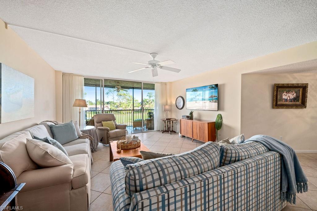 415 Augusta Boulevard, Unit 309 Naples, FL 34113 - Photo 24 of 36 a bedroom with furniture and a large window