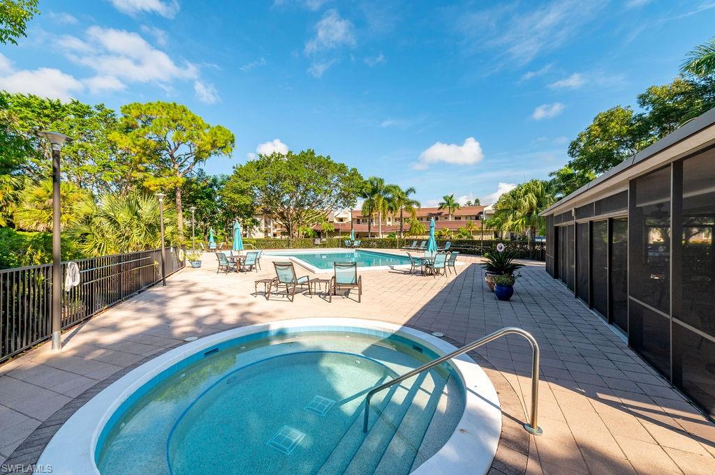415 Augusta Boulevard, Unit 309 Naples, FL 34113 - Photo 32 of 36 a view of a swimming pool with a patio
