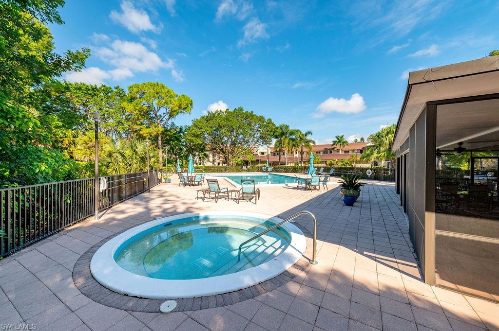 415 Augusta Boulevard, Unit 309 Naples, FL 34113 - Photo 33 of 36 a view of a swimming pool with a patio and a yard