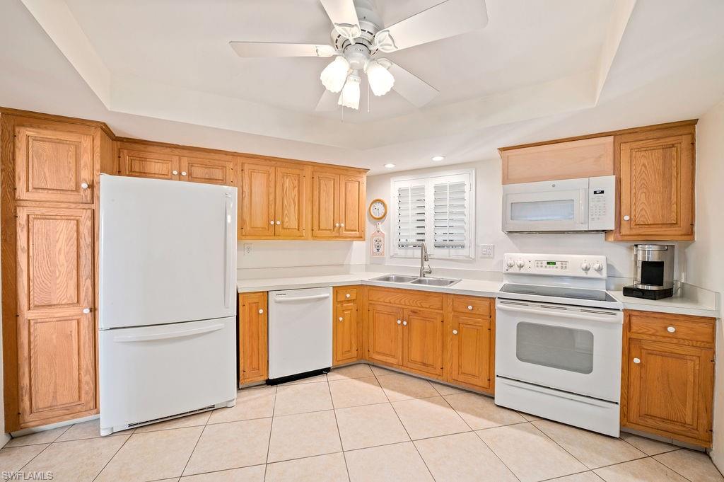 415 Augusta Boulevard, Unit 309 Naples, FL 34113 - Photo 4 of 36 a kitchen with granite countertop appliances cabinets and a sink