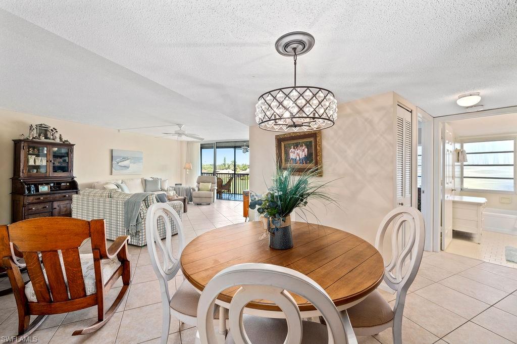 415 Augusta Boulevard, Unit 309 Naples, FL 34113 - Photo 5 of 36 a view of a dining room with furniture window and wooden floor