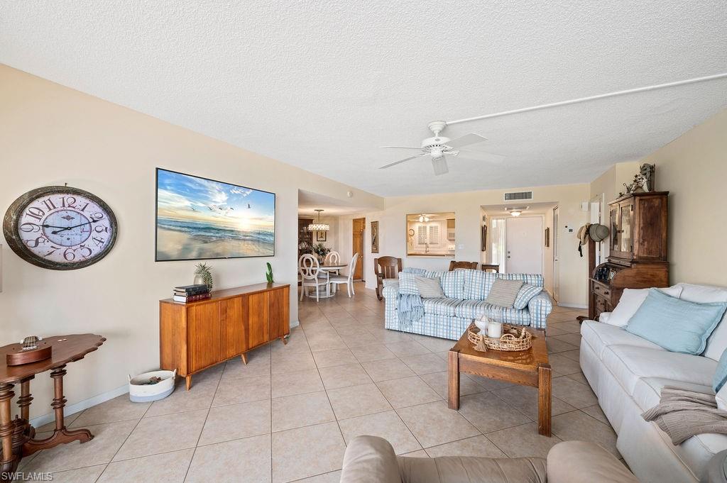 415 Augusta Boulevard, Unit 309 Naples, FL 34113 - Photo 8 of 36 a living room with furniture and a flat screen tv