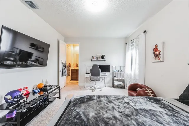 a bedroom with furniture or couch and a flat screen tv