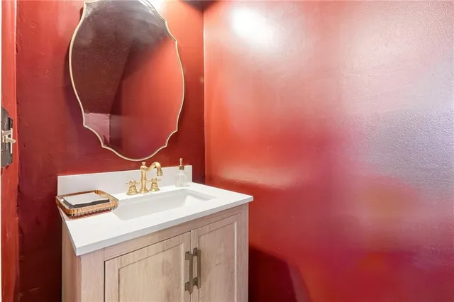 a bathroom with a sink vanity and a mirror