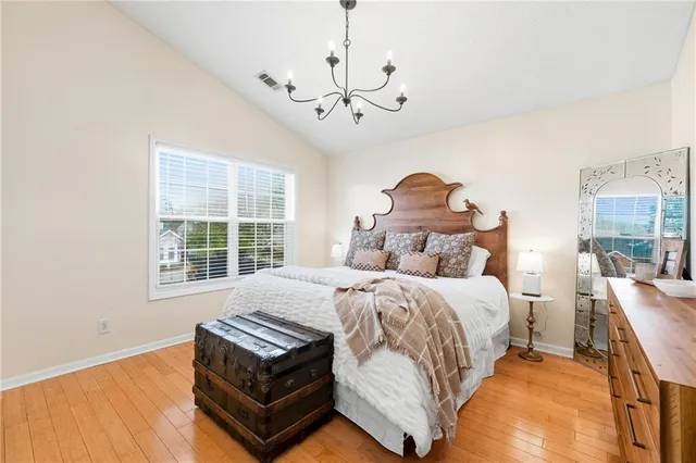 a bed room with a bed and a chandelier