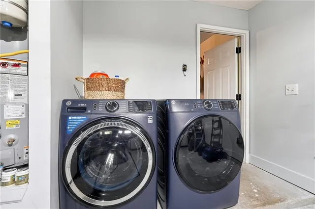 a view of a patio with table and chairs potted plants and floor to ceiling window
