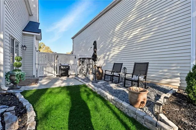 a view of a wooden deck and a backyard