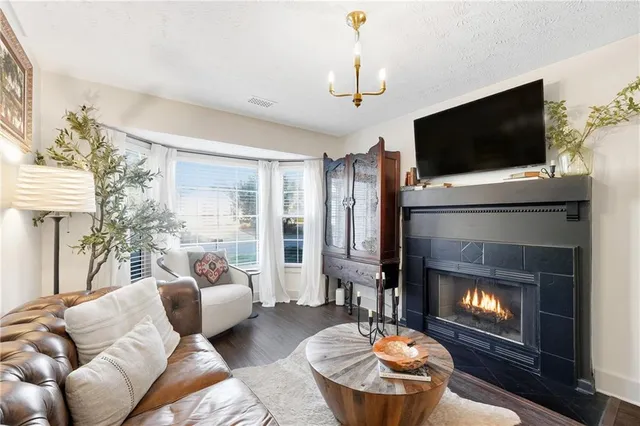 a living room with furniture a flat screen tv and a fireplace