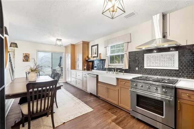 a kitchen with a stove a sink and a refrigerator
