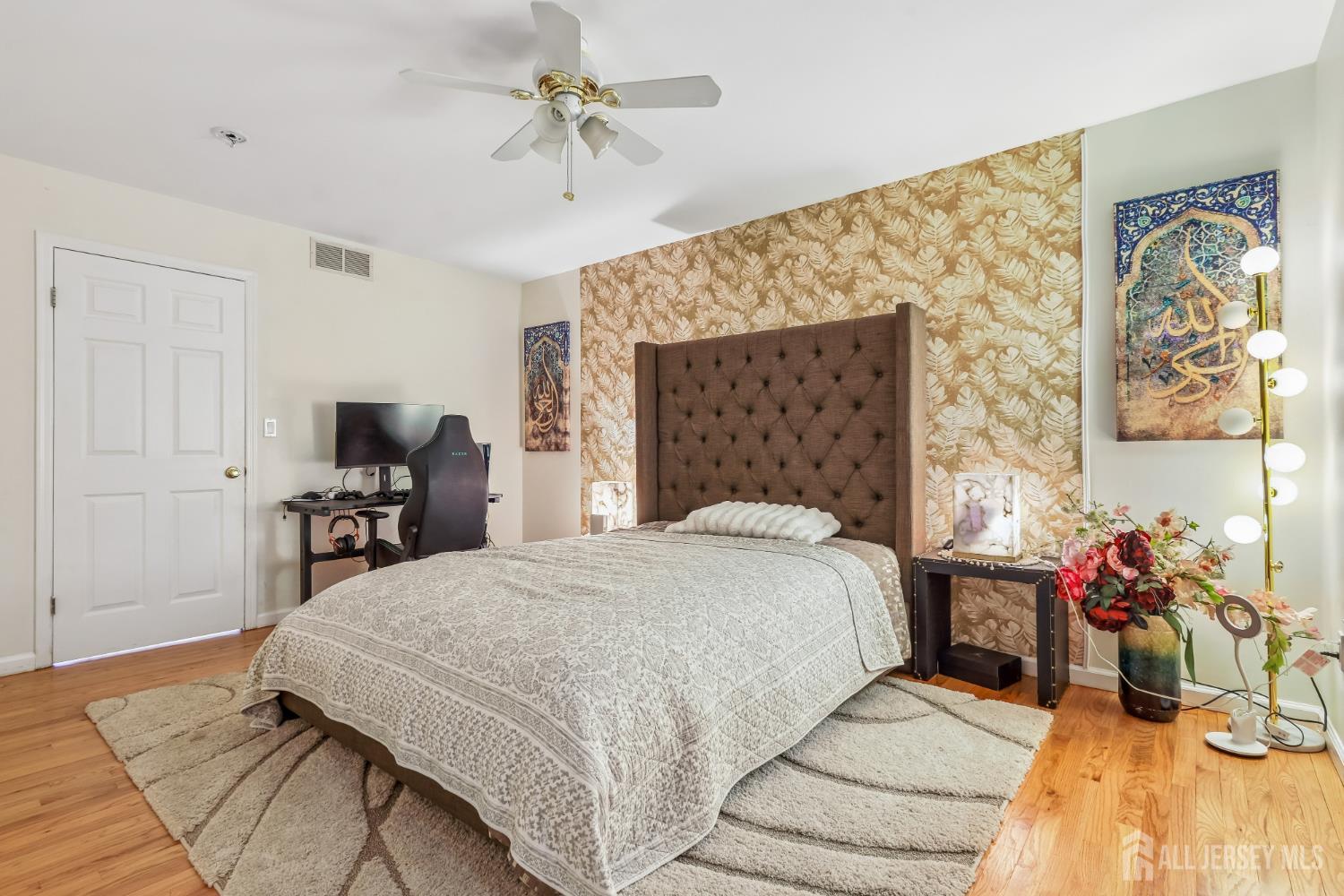 489 Plainfield Road Edison, NJ 08820 - Photo 19 of 39 a bedroom with a bed and a chandelier