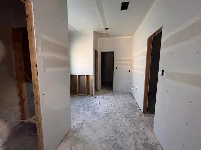 a view of an empty room with a fireplace and a window