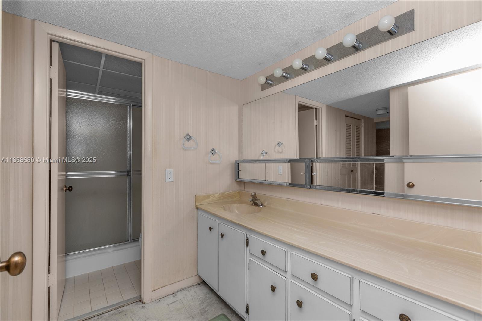 8277 Southwest 128th Street, Unit 108 Pinecrest, FL 33156 - Photo 12 of 34 a spacious bathroom with a granite countertop sink and mirror