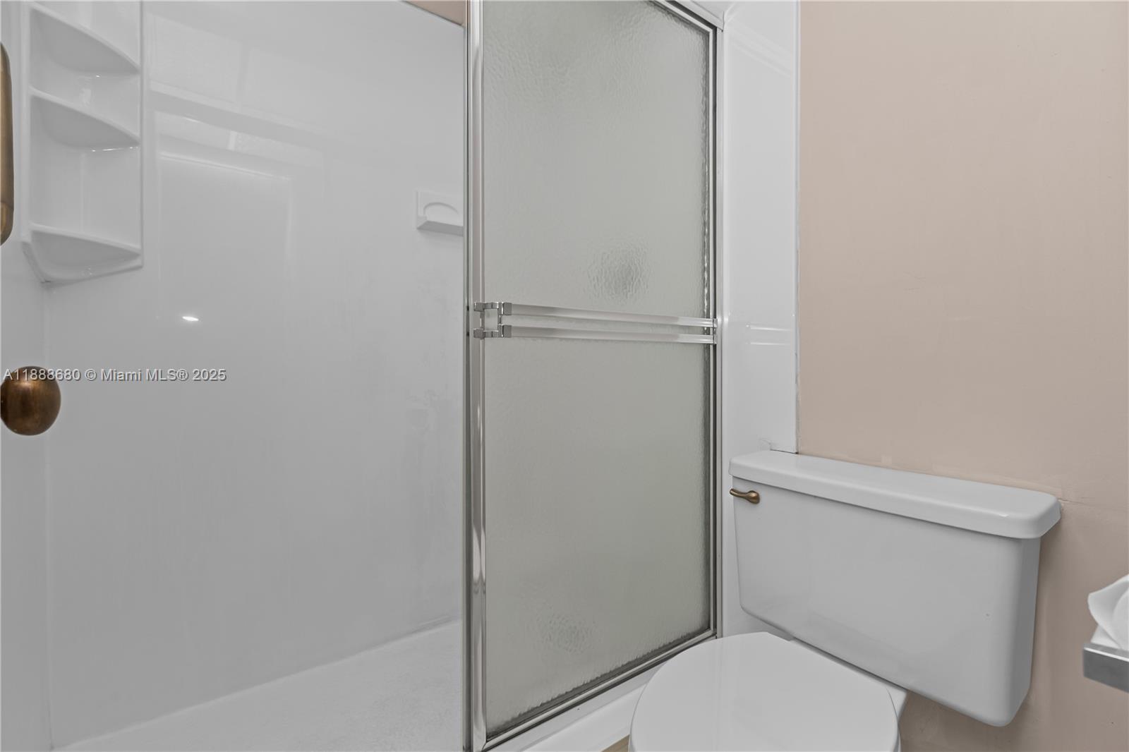 8277 Southwest 128th Street, Unit 108 Pinecrest, FL 33156 - Photo 14 of 34 a white toilet sitting next to a shower