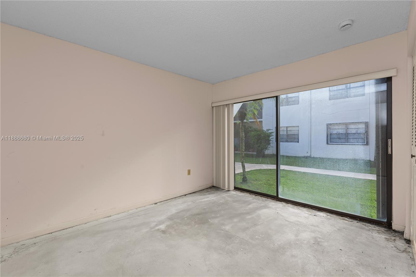 8277 Southwest 128th Street, Unit 108 Pinecrest, FL 33156 - Photo 16 of 34 an empty room with sliding glass door and shower