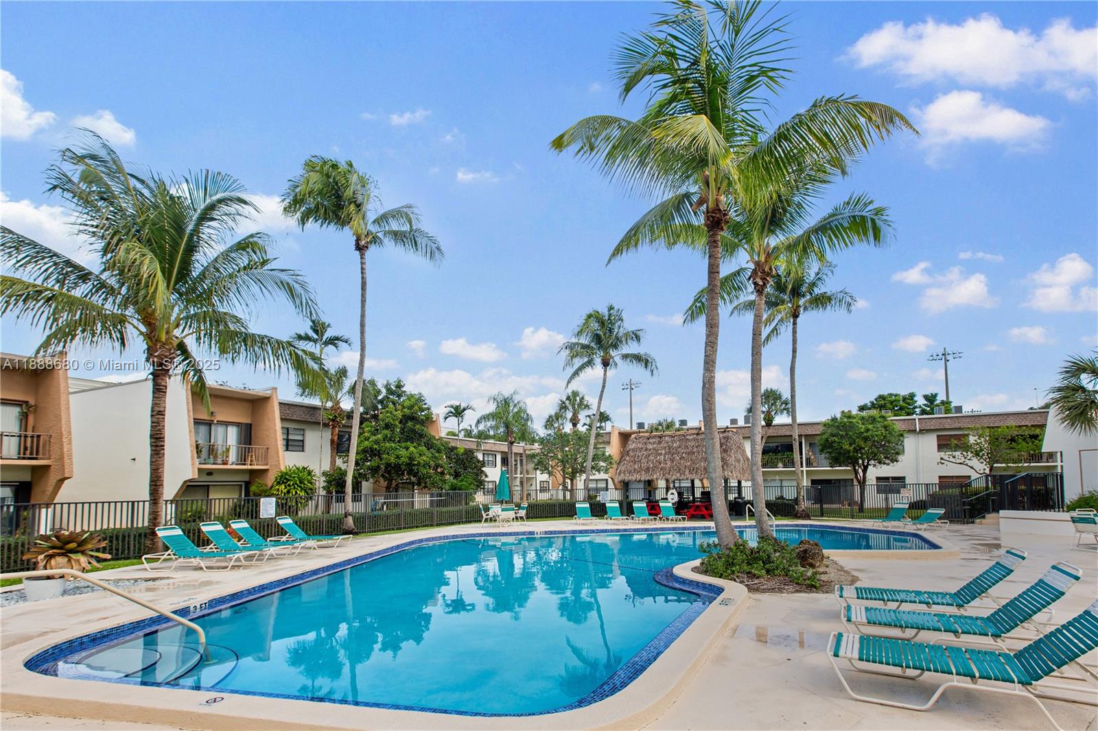 8277 Southwest 128th Street, Unit 108 Pinecrest, FL 33156 - Photo 27 of 34 a view of a swimming pool with a garden and outdoor seating