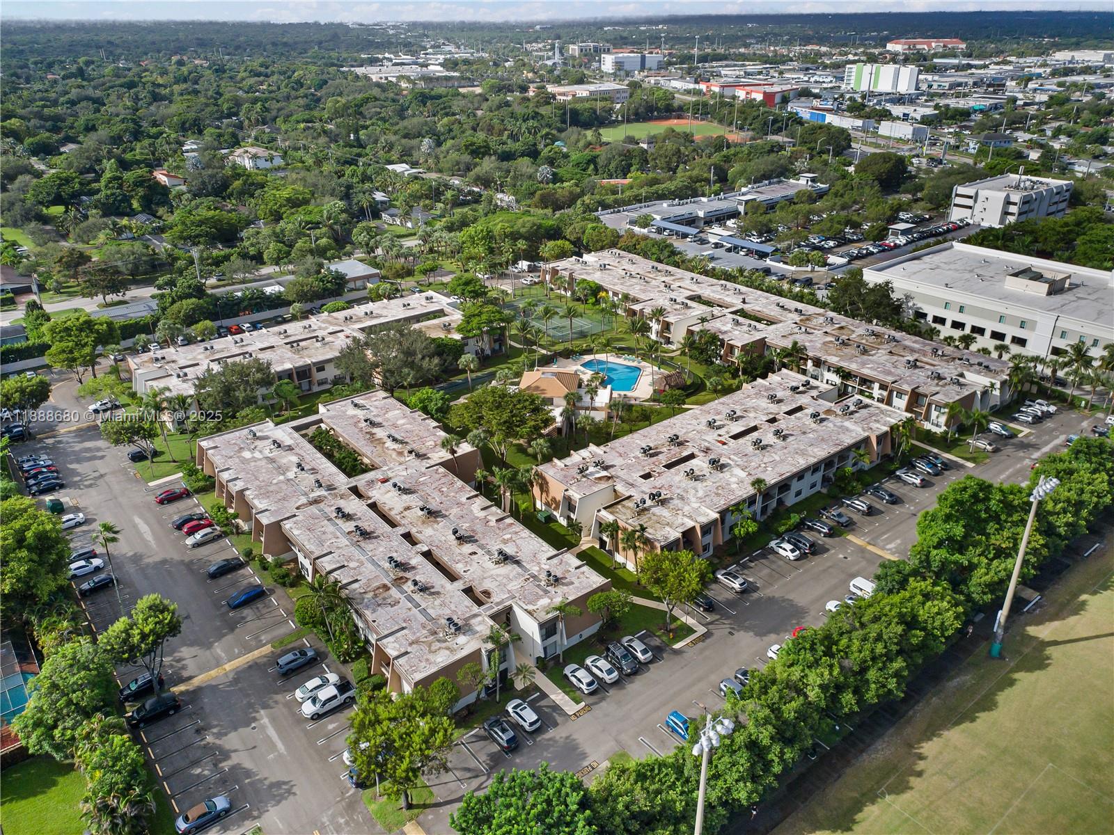 8277 Southwest 128th Street, Unit 108 Pinecrest, FL 33156 - Photo 31 of 34 an aerial view of a city with lots of residential buildings