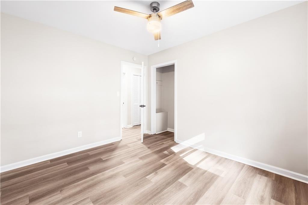 2773 Pasco Lane Southeast Atlanta, GA 30316 - Photo 12 of 40 a view of a room with wooden floor and a ceiling fan