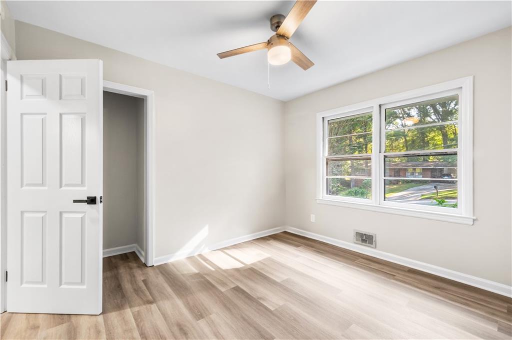 2773 Pasco Lane Southeast Atlanta, GA 30316 - Photo 13 of 40 an empty room with wooden floor and windows