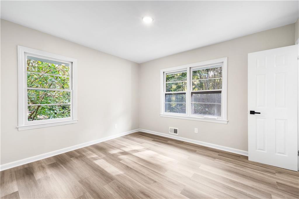 2773 Pasco Lane Southeast Atlanta, GA 30316 - Photo 14 of 40 an empty room with wooden floor and windows