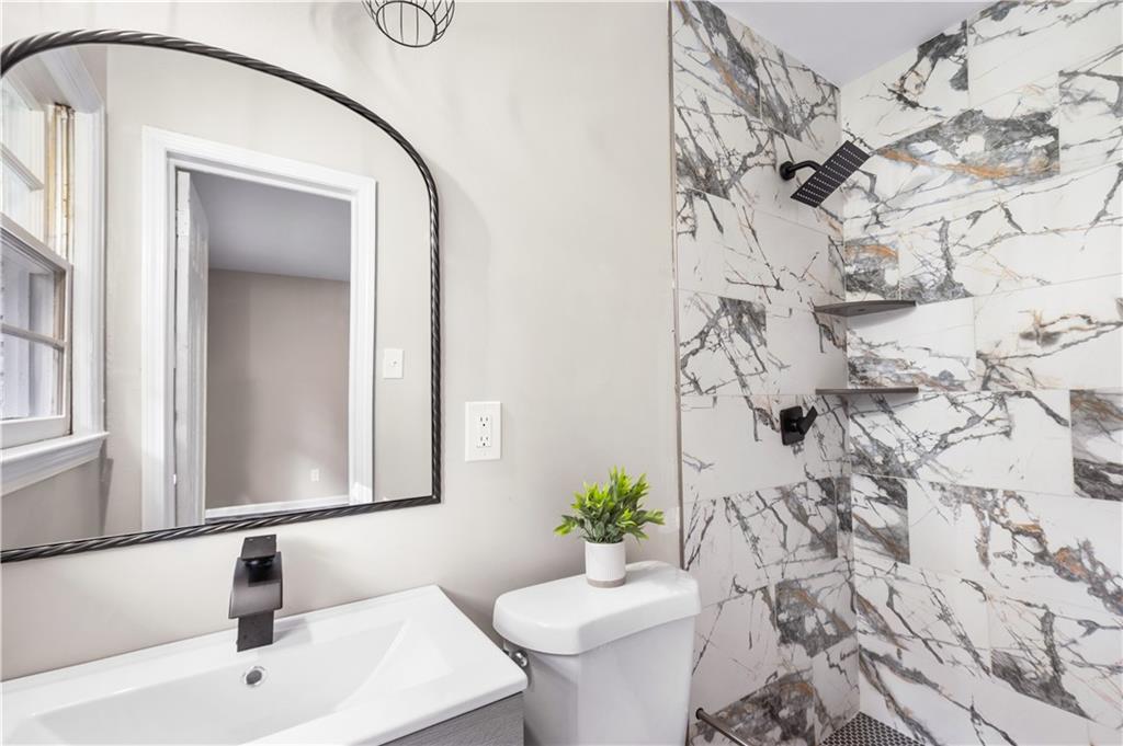 2773 Pasco Lane Southeast Atlanta, GA 30316 - Photo 16 of 40 a bathroom with a sink and a mirror