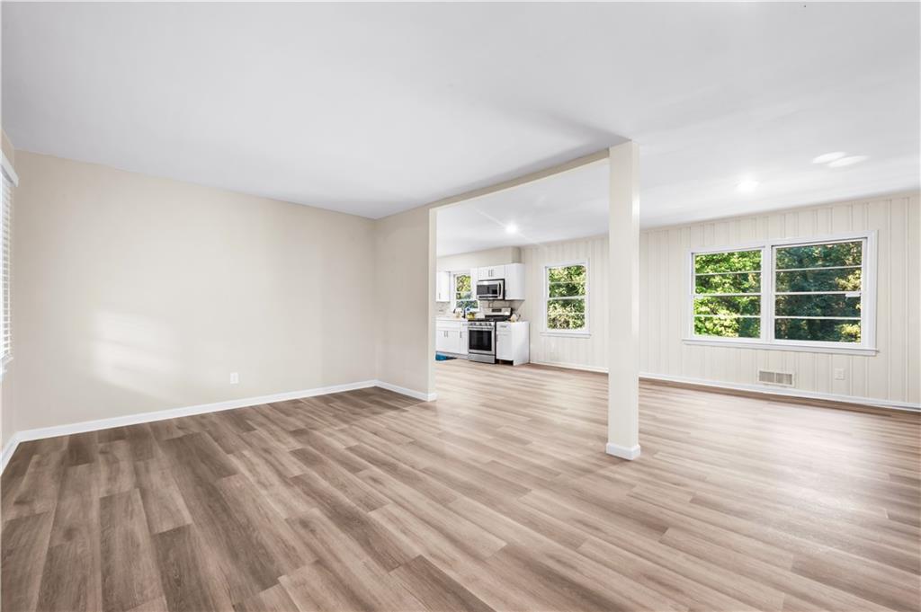 2773 Pasco Lane Southeast Atlanta, GA 30316 - Photo 3 of 40 an empty room with wooden floor and windows